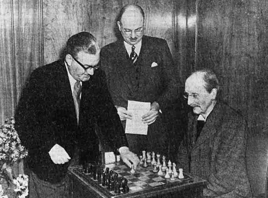 The Mayor of Cambridge makes the first move for Bertram Goulding Brown (1881-1965), watched by club president Horace Bernard Coulson (1907-1979), in a telephone match on 6 April 1954 between the Cambridge City and Oxford City clubs, won by Cambridge 5-3. Photo Cambridge Daily News, 7 April 1954